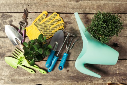 Front view of a Blackheath garden with tools and gardener starting work